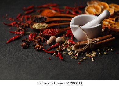 Mix of aromatic spices on dark stone table - Powered by Shutterstock