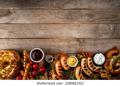 Mix Bar-b-q Sausages - Bavarian, Round, Gumberland, Bratwurst With Ketchup, Mustard Barbeque Sauce. Various Bbq Grilled Sausages Flat Lay On Wood Background. Street Festival Grill Food Menu. 