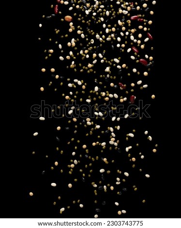 Mix beans fall down explosion, several multi kind bean float explode. Dried mixed white green red soy black peanut beans splash throwing in Air. Black background Isolated