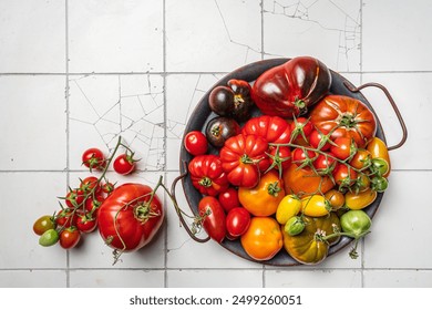 Mix colorful tomatoes in summer day. Composition of variety fresh tomatoes. White tile background. Top view. - Powered by Shutterstock