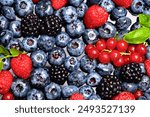 Mix of different berry berries. Berries fruits background. Antioxidants, detox diet, organic berries. Wild berries pattern. Berry background.