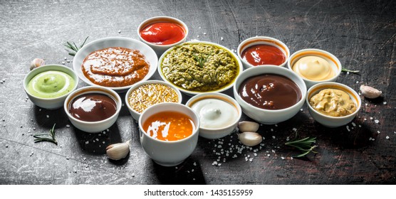 Mix from different kinds of sauces. On dark rustic background
