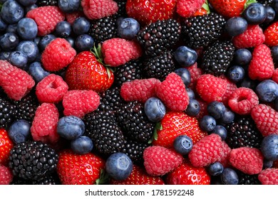 Mix of different ripe tasty berries as background, top view - Powered by Shutterstock