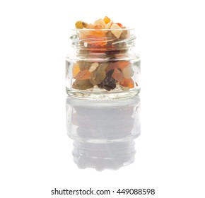 Mix Dried Fruit Pieces In Mason Jar Over White Background