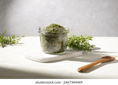 Mix of dried green herbs spice in a glass jar - Powered by Shutterstock