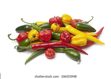 Mix of fresh colorful hot chili peppers isolated on white background