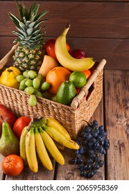 Mix Of Fresh Juicy Colorful Exotic Tropical Fruits In Basket On Wooden Background