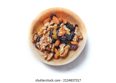 Mix Fruit And Nut Mix In A Small Wooden Cup On A White Background. Healthy Choice For Energy. Raisins, Walnut, Almond In A Bowl. Nature Product. Top Down View.