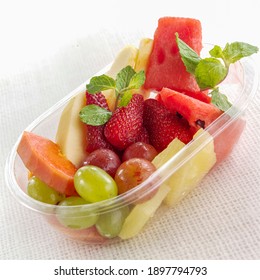 Mix Fruit In Plastic Tray On White Sackcloth Background.