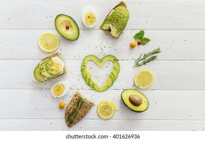 Mix of green vegetables and fruits on old wooden table, top view - Powered by Shutterstock