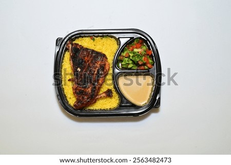 Mix Grilled with rice shish kabab shish tawook,chicken,kufta kebab,salad,bread,Mix grill. chicken tikka .Served on take away box on a white background, top view. Flat lay, overhead,from above.