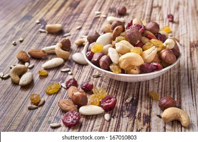 Mix Nuts And Dry Fruits On Wooden Background