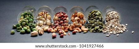Mix Nuts in the glass on black background close up , peanut peas sunflower seeds  pumpkin seeds cashew nuts  pistachios