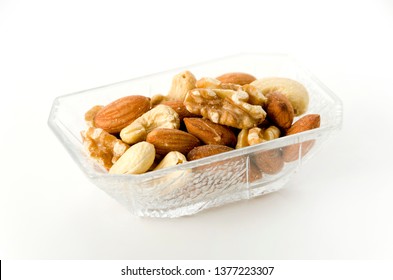 Mix Of Nuts In A Square Glass Bowl On A White Background. 