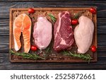 Mix of raw meat and fish . Salmon , beef , pork , chicken staek . Top view photography