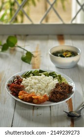 Mix Rice Is A Typical Indonesian Dish, Consisting Of White Rice And Various Side Dishes, Beef, Stir-fried Tofu, Tempeh Oreg, Sweet And Sour Chicken, Stir-fried Broccoli. Served On A Plate. 