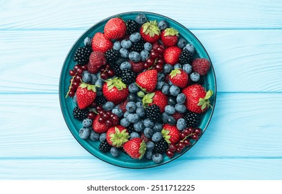 Mix of ripe colorful berries in bowl photography . Blueberry , strawberry , raspberry , blackberry and red currant . Top view on rustic background - Powered by Shutterstock