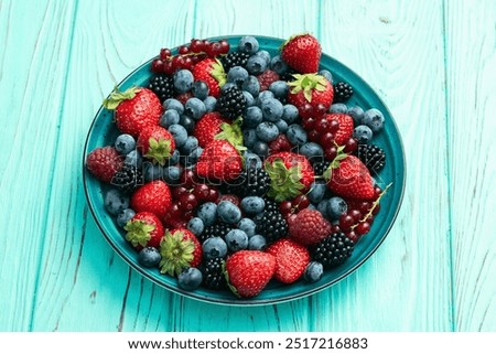 Similar – Bowl with red berries and mint leaves