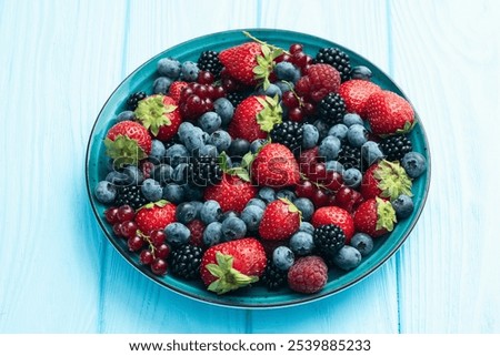 Similar – Bowl with red berries and mint leaves