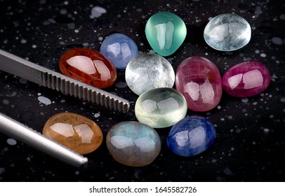 Mix Round cut mineral gemstones with dark stones background.