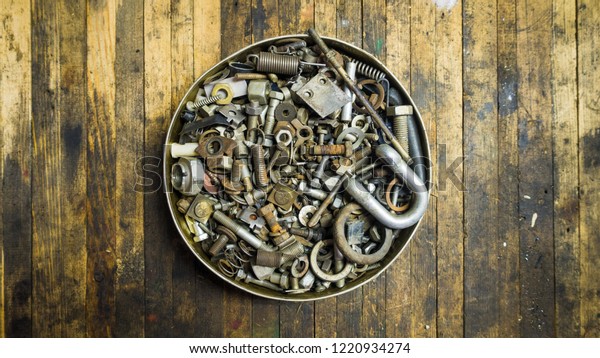 Mix of rusty
auto scrap including nuts, bolts, springs, washers, cotter pins,
collected in the old metallic
can.