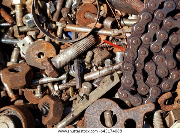 Mix of rusty auto scrap\
including nuts, bolts and a chain. Background that can be used for\
text.