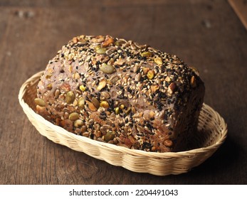 Mix seed and nut crusted bread loaf in basket - Powered by Shutterstock