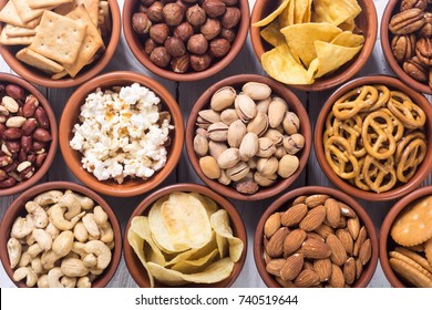 Mix of snacks : pretzels , crackers , chips , nuts and nachos - Powered by Shutterstock