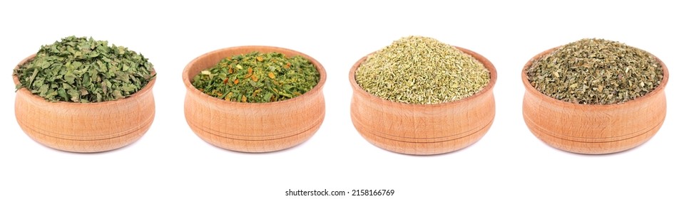Mix of spices and seasonings isolated in wooden bowl, isolated on white background. Dry organic herbs. Ingredient for cooking