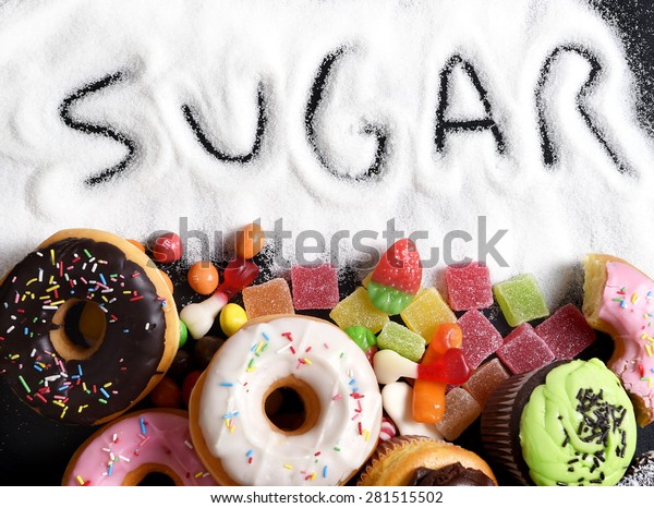 mix of sweet cakes, donuts and candy with\
sugar spread and written text in unhealthy nutrition, chocolate\
abuse and addiction concept, body and dental\
care