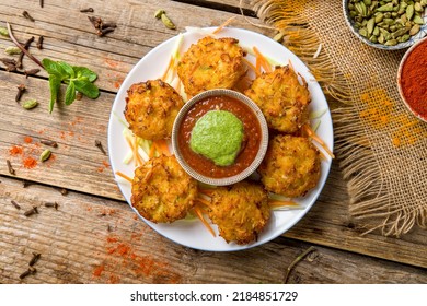 Mix Veg Pakora With Tomato Mint Sauce On Old Wooden Table Top View