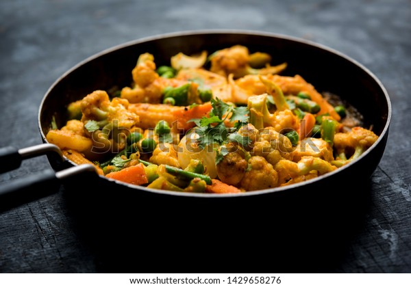 Mix vegetable curry - Indian main course recipe\
contains Carrots, cauliflower, green peas and beans, baby corn,\
capsicum and paneer/cottage cheese with traditional masala and\
curry, selective focus