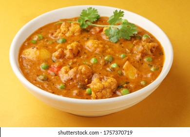 MIX VEGETABLE CURRY- Indian Recipe, Mixed Veg Containing Carrots, Cauliflower, Green Peas And Beans With Traditional Masala And Curry, Red Hot And Spicy Served In A Ceramic Bowl