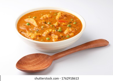 MIX VEGETABLE CURRY- indian recipe, mixed veg containing Carrots, cauliflower, green peas and beans with traditional masala and curry, red hot and spicy served in a ceramic bowl - Powered by Shutterstock