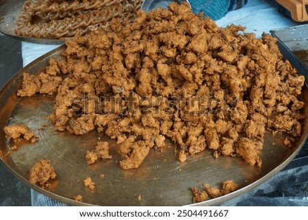 Mix vegetable pakora making and being displayed by a street food vendor, Crispy onion and potato pakoda selling on a market, Spicy veg pakora or pakoda displayed on a rural fair for sale