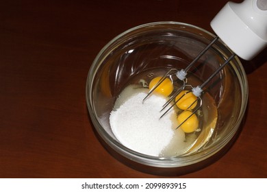 Mix Yolks and Proteins with sugar on  culinary background. Beating Mixing chicken proteins and yolks in cooking. Cooking with blender.