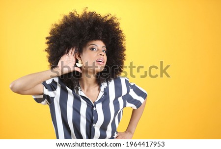mixed afro woman, with hearing problems, hand on ear yellow background