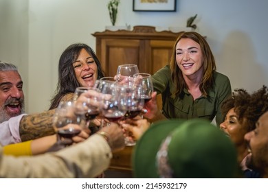 Mixed Age Range Group Of Friends Toasting At Dinner Party, Focus On Women Face, Italian Wine Drinking Glasses