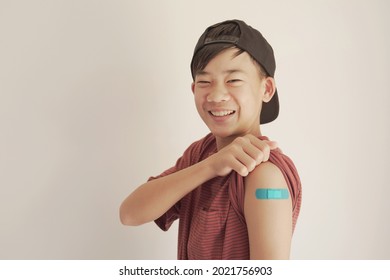 Mixed Asian Teen Boy Showing His Arm With Blue Bandage After Got Vaccinated Or  Inoculation, Child Immunization, Covid Delta Vaccine Concept
