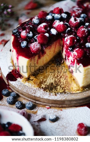Mixed berries cheesecake with a slice cut out