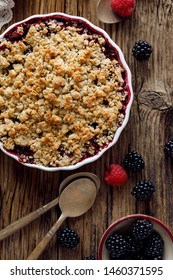 Mixed Berry Crumble In A Baking Dish On A Wooden Table, Top View, Close-up