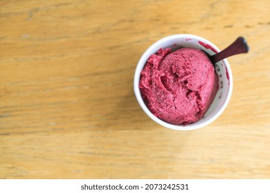 Mixed Berry Ice-cream Scoop In Cup On Wood Table