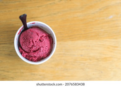 Mixed Berry Ice-cream Scoop In Cup On Wood Table