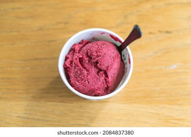 Mixed Berry Ice-cream Scoop In Cup On Wood Table