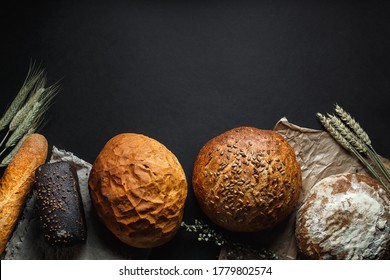 Mixed Breads On Black Stone Table. Top View With Copy Space.