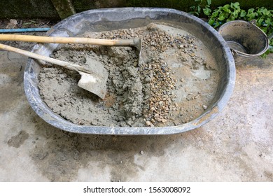 Mixed Cement Mortar With Hoe Leak Inside Big Bucket On Floor Background