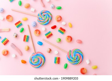 Mixed collection of colorful candy, on pink background. Flat lay, top view - Shutterstock ID 1909889203