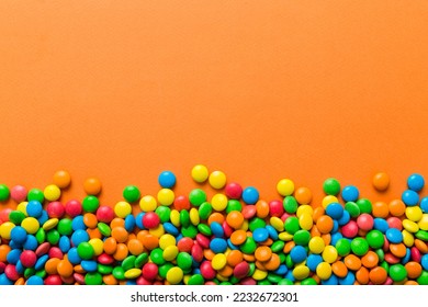 Mixed collection of colorful candy, on colored background. Flat lay, top view. frame of colorful chocolate coated candy. - Powered by Shutterstock