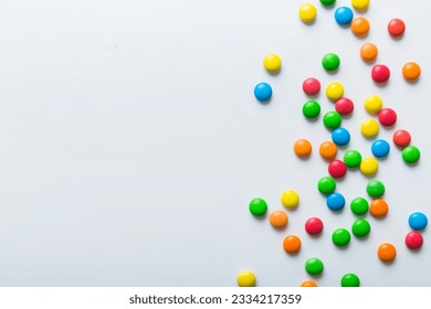 Mixed collection of colorful candy, on colored background. Flat lay, top view. frame of colorful chocolate coated candy. - Powered by Shutterstock