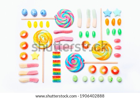 Mixed collection of colorful candy, on white background. Flat lay, top view